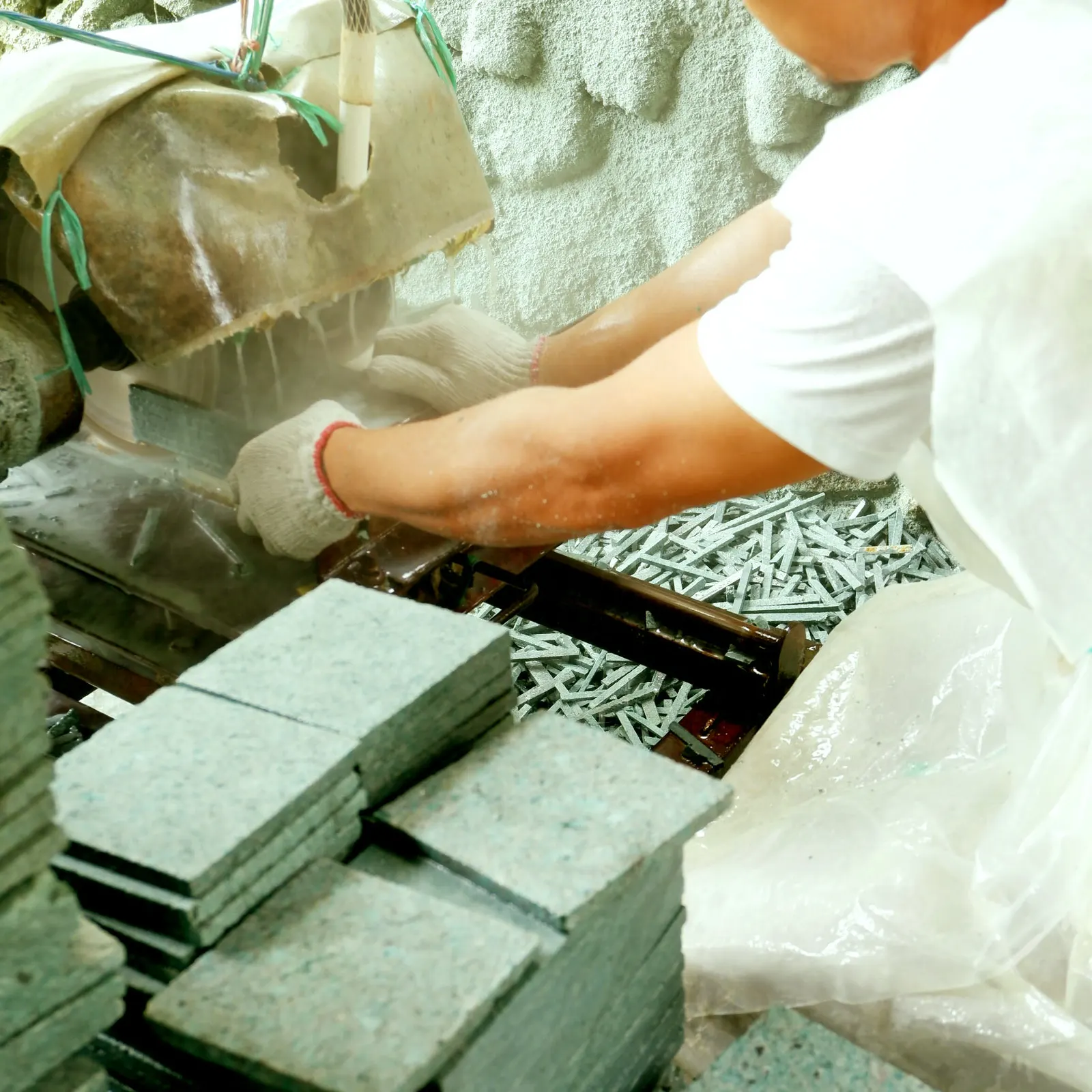 Finished Sukabumi Green Stone tiles being trimmed and stacked for quality inspection